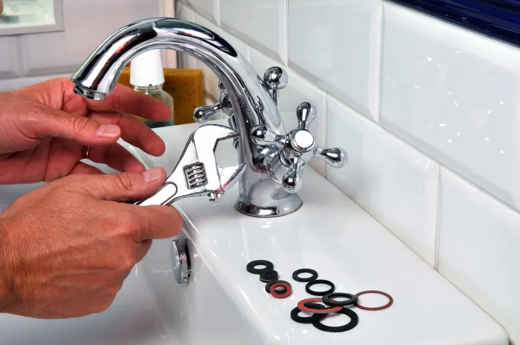 Plumber performing maintenance on a bathroom faucet in San Jacinto