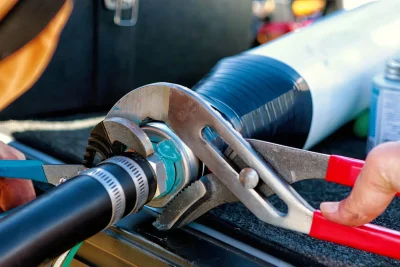 Technician tightening an industrial pipe connection in San Jacinto
