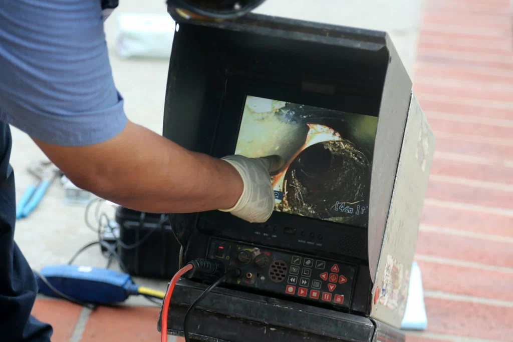 Technician viewing a drain inspection camera in San Jacinto