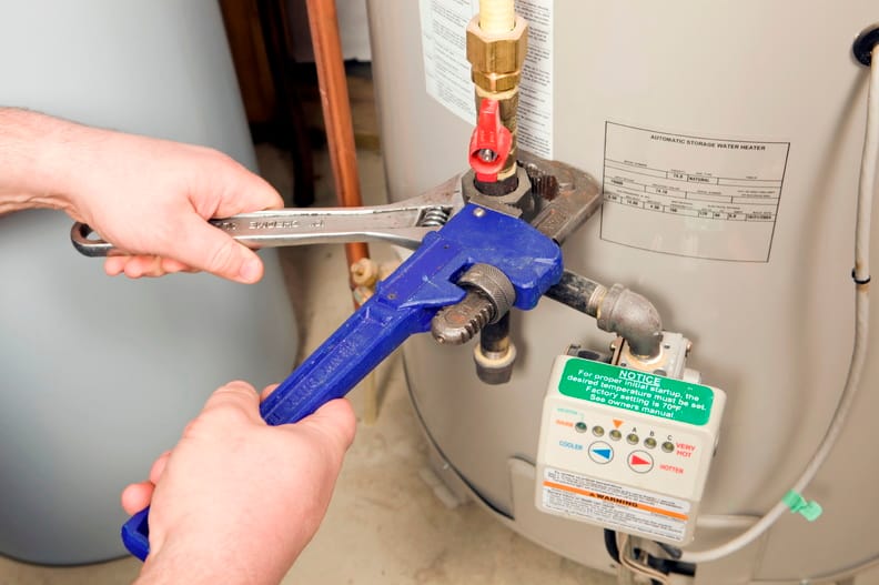 Plumber repairing a water heater valve in San Jacinto